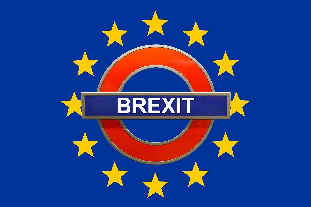 brexit logo surrounded by red circle, yellow stars, blue background